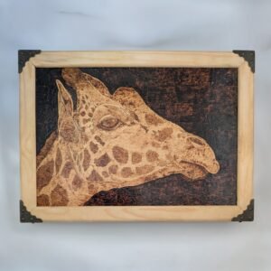 Pyrograohy of a giraffe's head with a dark backround, mounted in a light wood frame with brass-effect corners